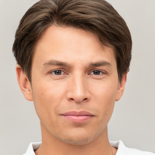 Joyful white young-adult male with short  brown hair and grey eyes