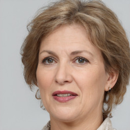 Joyful white adult female with medium  brown hair and grey eyes