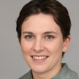 Joyful white young-adult female with medium  brown hair and grey eyes