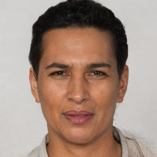 Joyful latino adult male with short  black hair and brown eyes