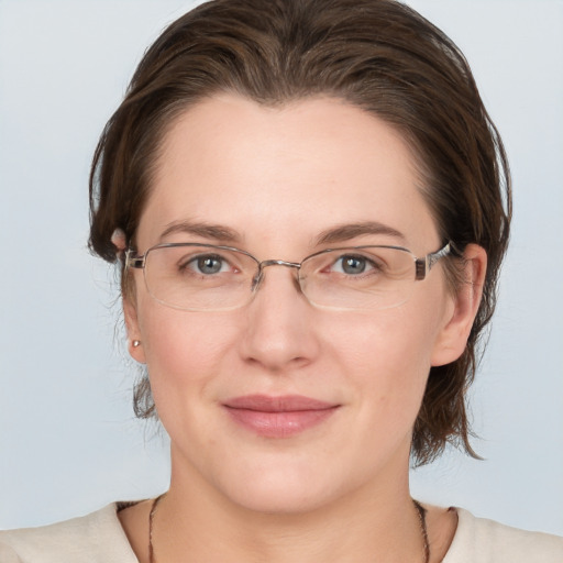 Joyful white adult female with medium  brown hair and grey eyes