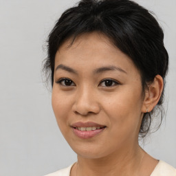 Joyful asian young-adult female with medium  brown hair and brown eyes