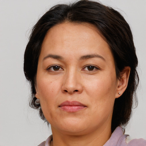 Joyful white adult female with medium  brown hair and brown eyes