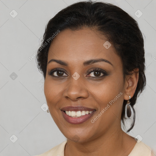 Joyful black young-adult female with medium  brown hair and brown eyes