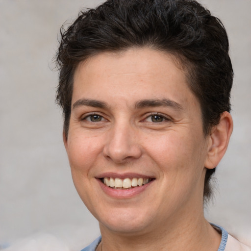 Joyful white adult female with short  brown hair and brown eyes