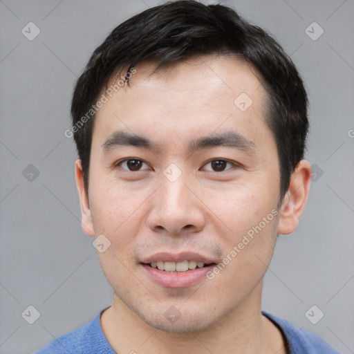 Joyful asian young-adult male with short  black hair and brown eyes