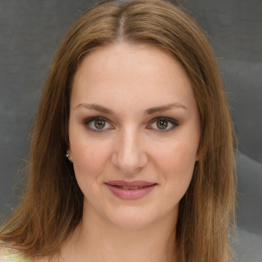 Joyful white young-adult female with long  brown hair and green eyes