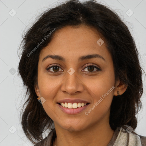 Joyful latino young-adult female with long  brown hair and brown eyes