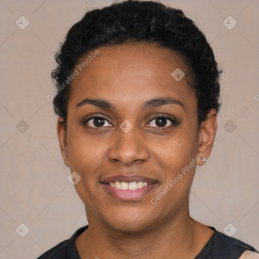 Joyful black young-adult female with short  black hair and brown eyes