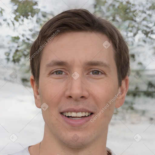 Joyful white adult male with short  brown hair and grey eyes