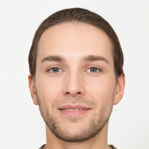 Joyful white young-adult male with short  brown hair and grey eyes