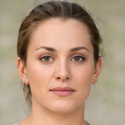 Joyful white young-adult female with medium  brown hair and green eyes