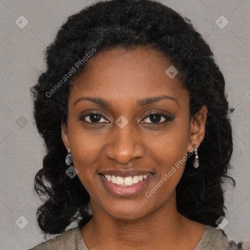 Joyful black young-adult female with long  black hair and brown eyes