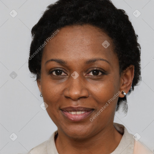 Joyful black adult female with short  black hair and brown eyes