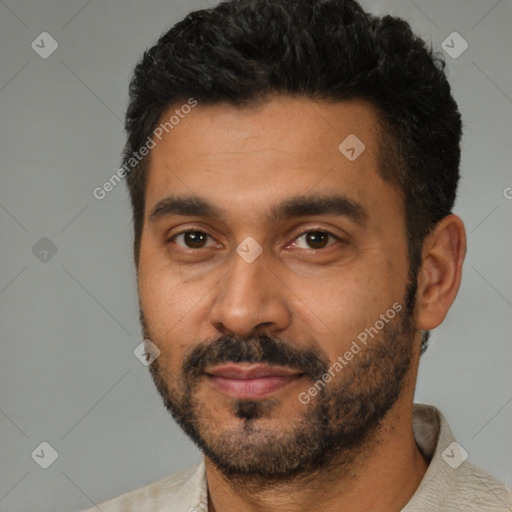 Joyful latino young-adult male with short  black hair and brown eyes