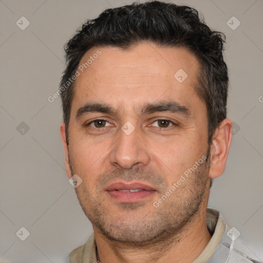 Joyful white adult male with short  black hair and brown eyes