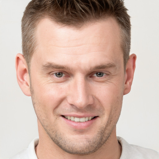 Joyful white adult male with short  brown hair and brown eyes