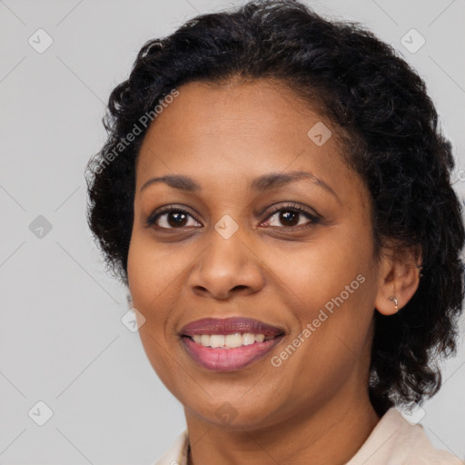 Joyful black adult female with long  brown hair and brown eyes