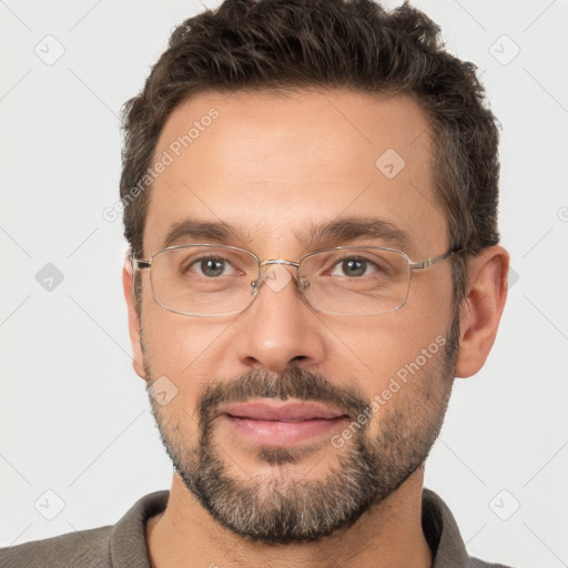 Joyful white adult male with short  brown hair and brown eyes