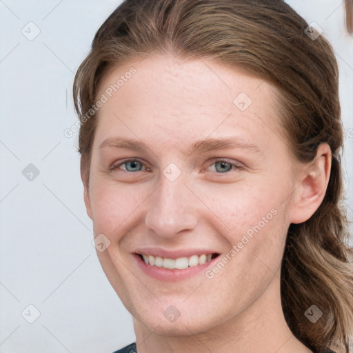 Joyful white young-adult female with medium  brown hair and grey eyes