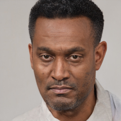 Neutral latino adult male with short  black hair and brown eyes