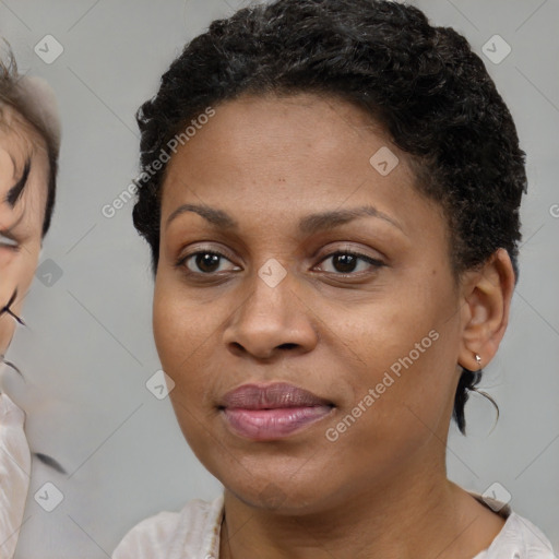 Joyful black young-adult female with short  brown hair and brown eyes