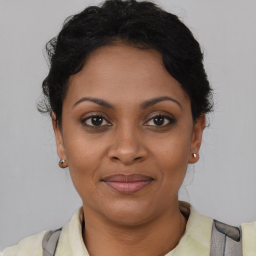 Joyful black young-adult female with short  brown hair and brown eyes