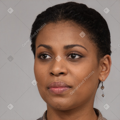 Joyful black young-adult female with short  black hair and brown eyes