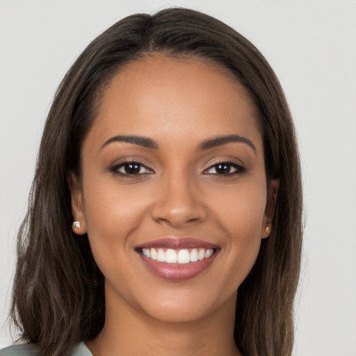 Joyful white young-adult female with long  brown hair and brown eyes