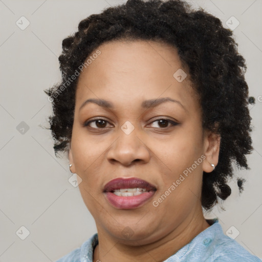 Joyful black adult female with short  brown hair and brown eyes