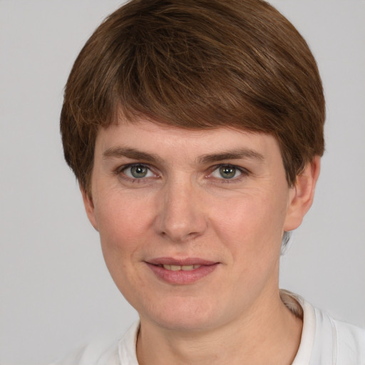 Joyful white young-adult female with short  brown hair and grey eyes