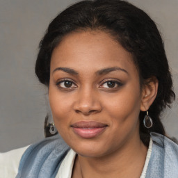 Joyful black young-adult female with medium  brown hair and brown eyes