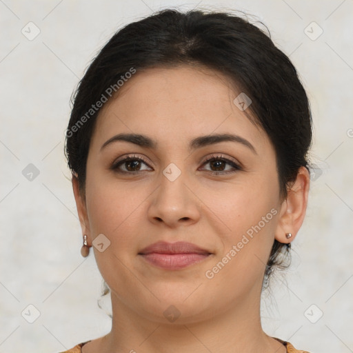 Joyful latino young-adult female with medium  brown hair and brown eyes