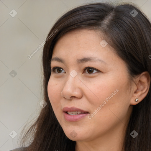 Joyful white adult female with long  brown hair and brown eyes