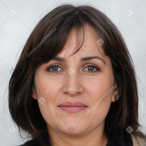 Joyful white adult female with long  brown hair and brown eyes