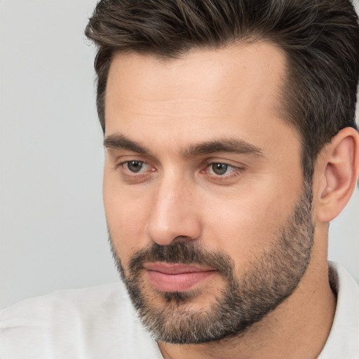 Joyful white young-adult male with short  brown hair and brown eyes