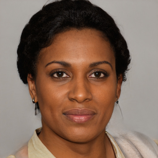 Joyful black young-adult female with short  brown hair and brown eyes