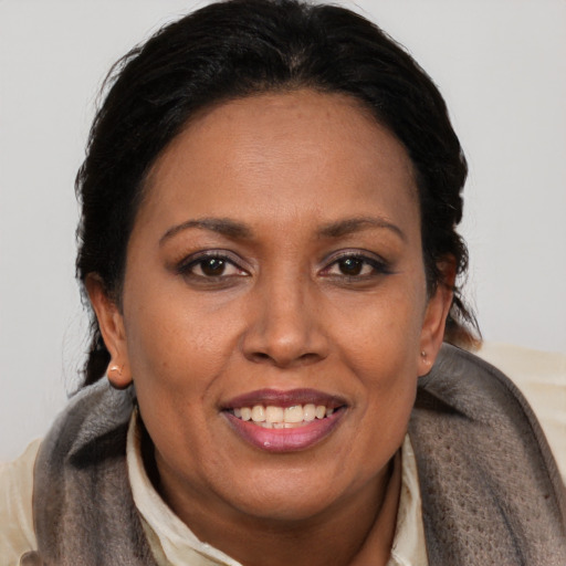 Joyful black adult female with short  brown hair and brown eyes