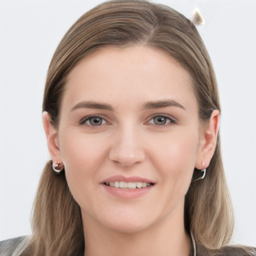 Joyful white young-adult female with long  brown hair and grey eyes