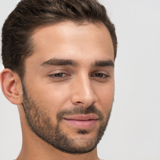 Joyful white young-adult male with short  brown hair and brown eyes