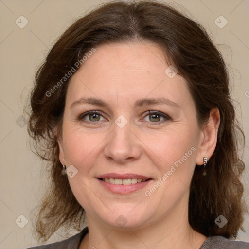 Joyful white adult female with medium  brown hair and grey eyes