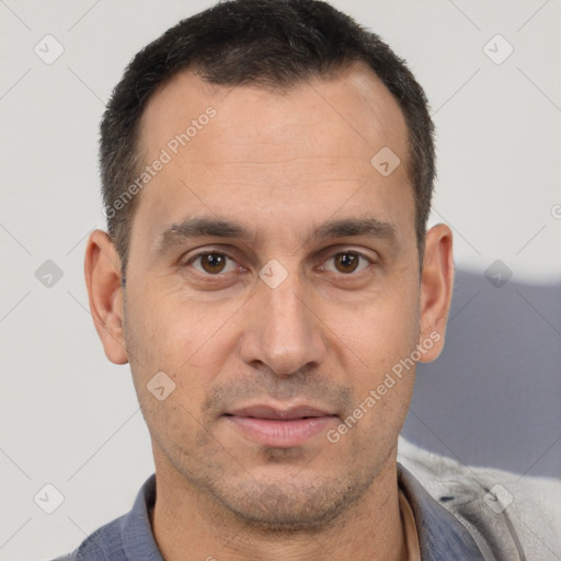 Joyful white adult male with short  brown hair and brown eyes