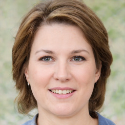 Joyful white young-adult female with medium  brown hair and green eyes