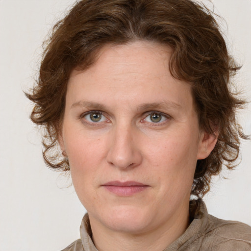 Joyful white young-adult female with medium  brown hair and green eyes