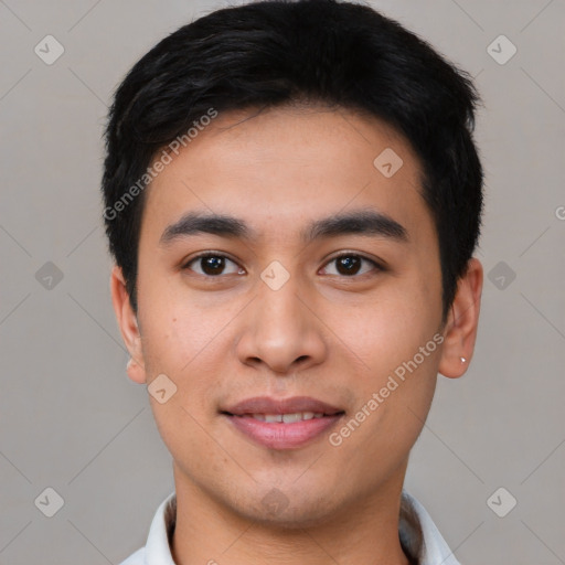 Joyful asian young-adult male with short  black hair and brown eyes