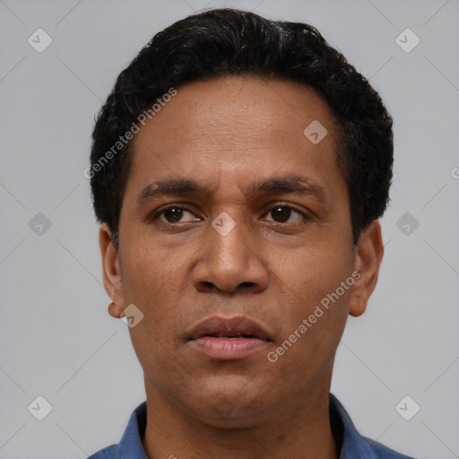 Neutral latino adult male with short  black hair and brown eyes