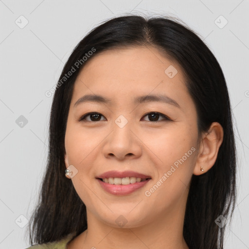 Joyful asian young-adult female with long  brown hair and brown eyes