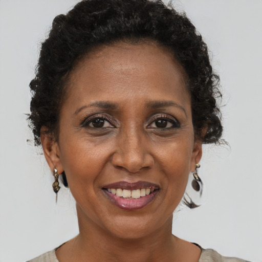 Joyful black adult female with short  brown hair and brown eyes