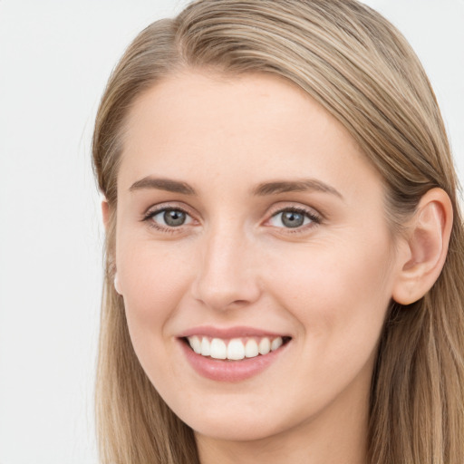 Joyful white young-adult female with long  brown hair and grey eyes