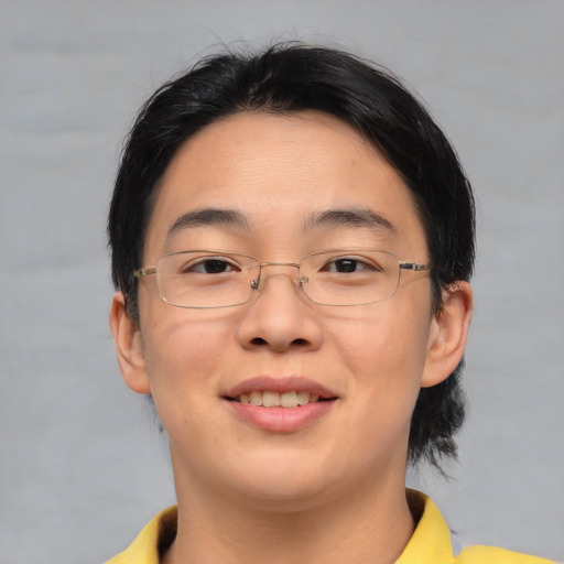 Joyful asian young-adult female with short  brown hair and brown eyes